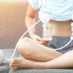 Mom breast pumping on the couch