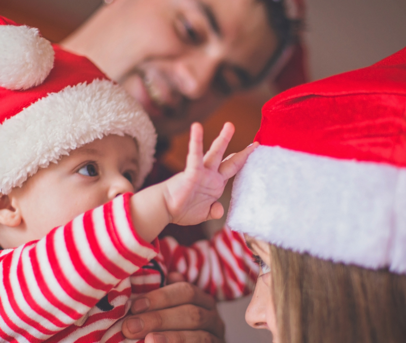 Family-dressed-in-Santa-Hats-Baby's-First-Christmas